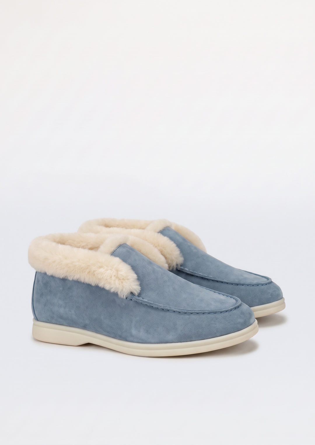 Courchevel Shearling Loafers in Sky Blue, pair on a light grey studio background