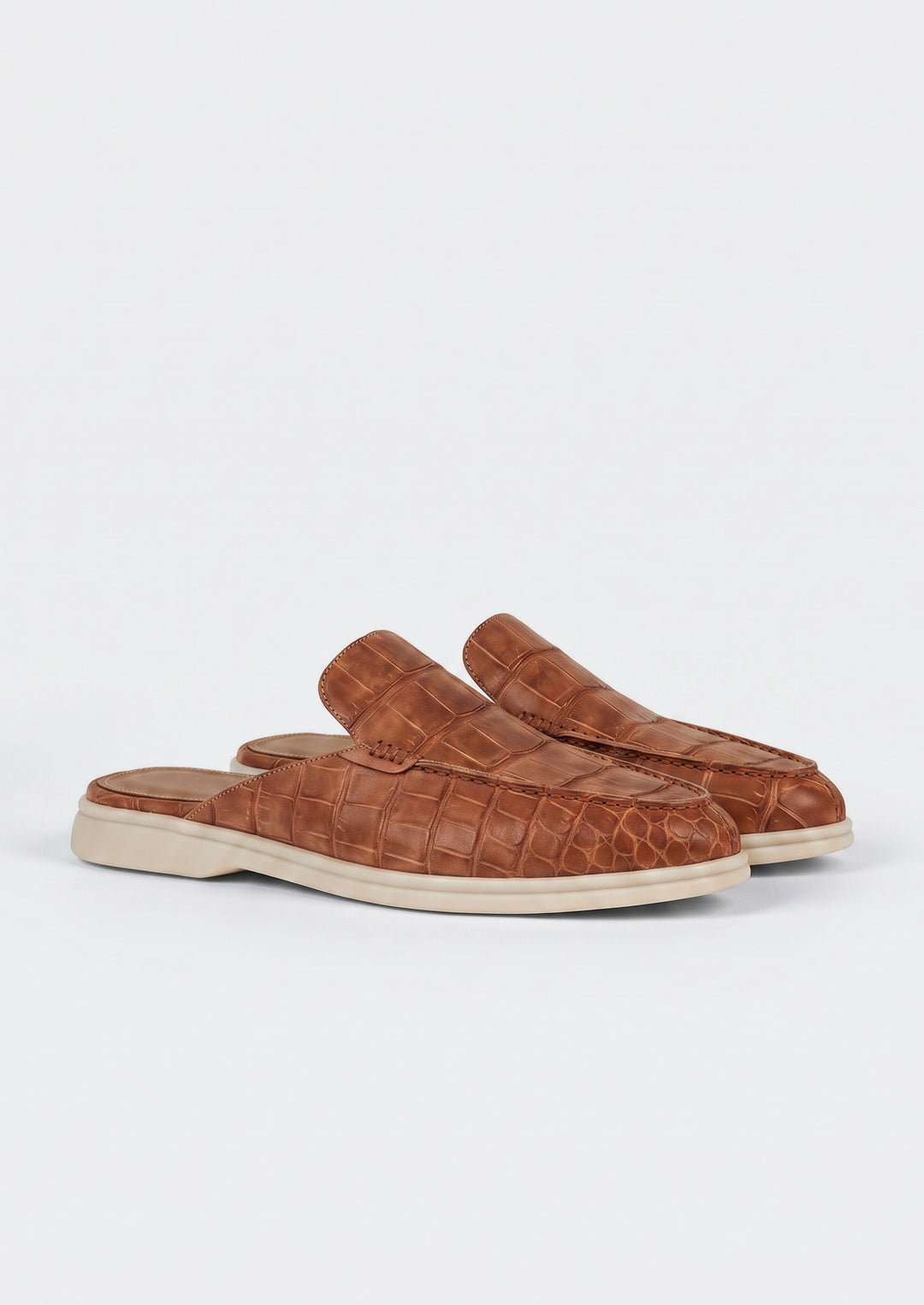 Porto Cervo Croc Mules in Brown, pair on a light grey studio background