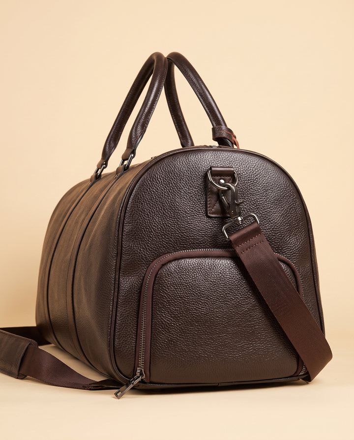 The Gstaad 55 leather travel bag in brown, end view with the shoe compartment