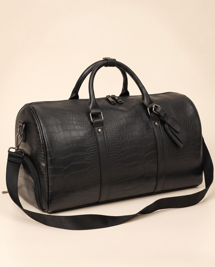 The Lucerne 50 croc weekender in black, three-quarter view on a cream studio backdrop
