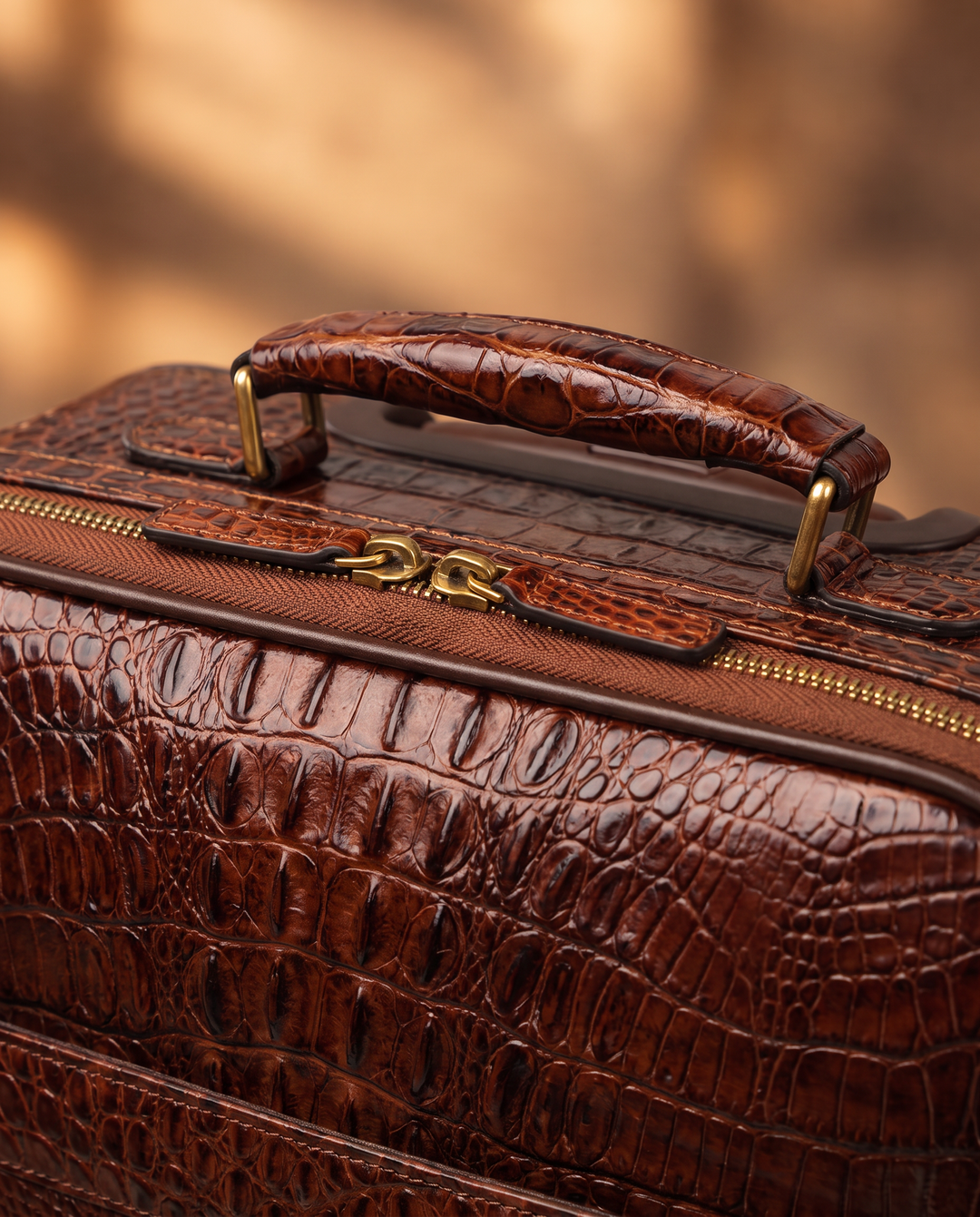 The Zermatt 58 crocodile trolley case in coffee brown, detail close-up